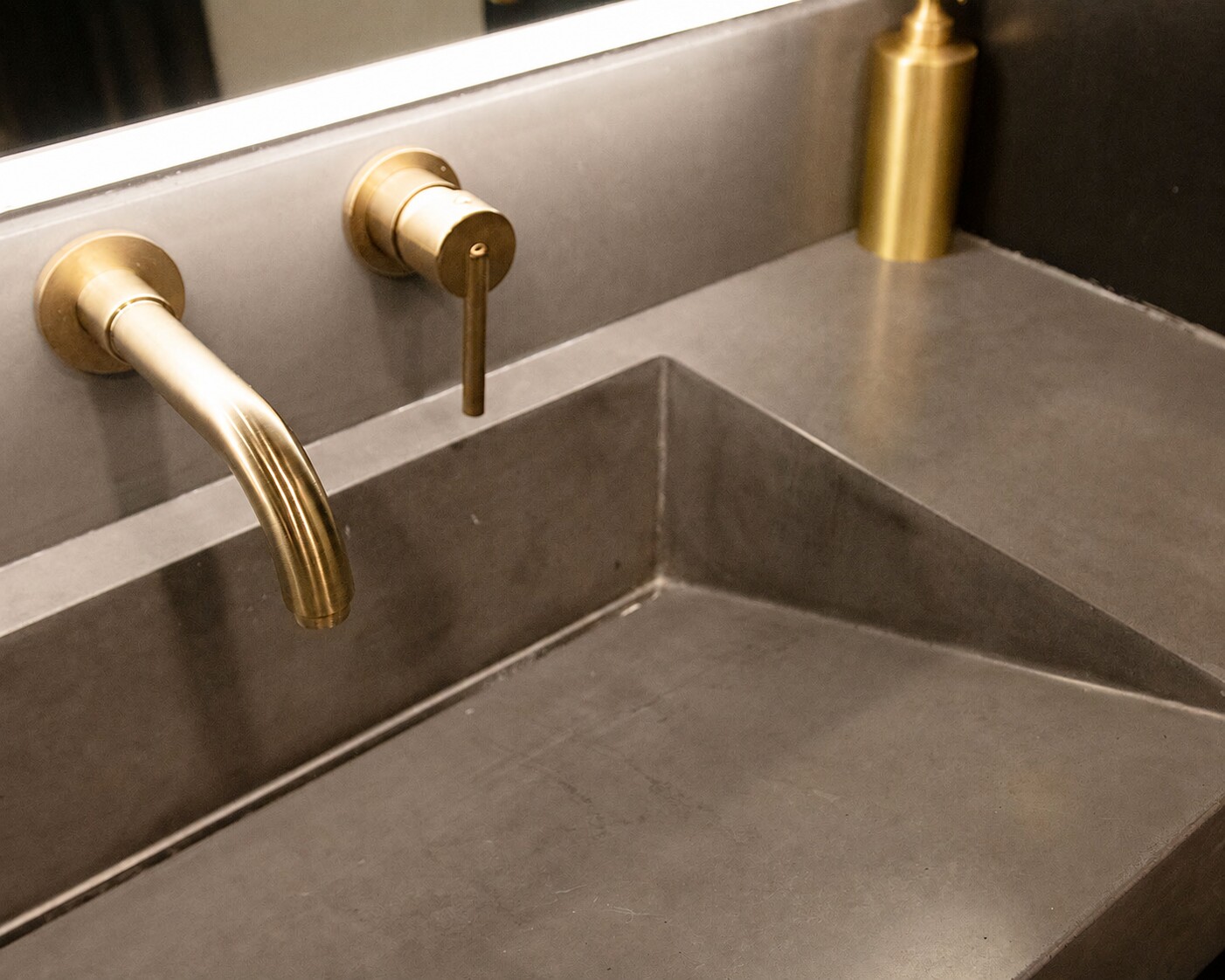 Brass inlay detail in a custom concrete bar