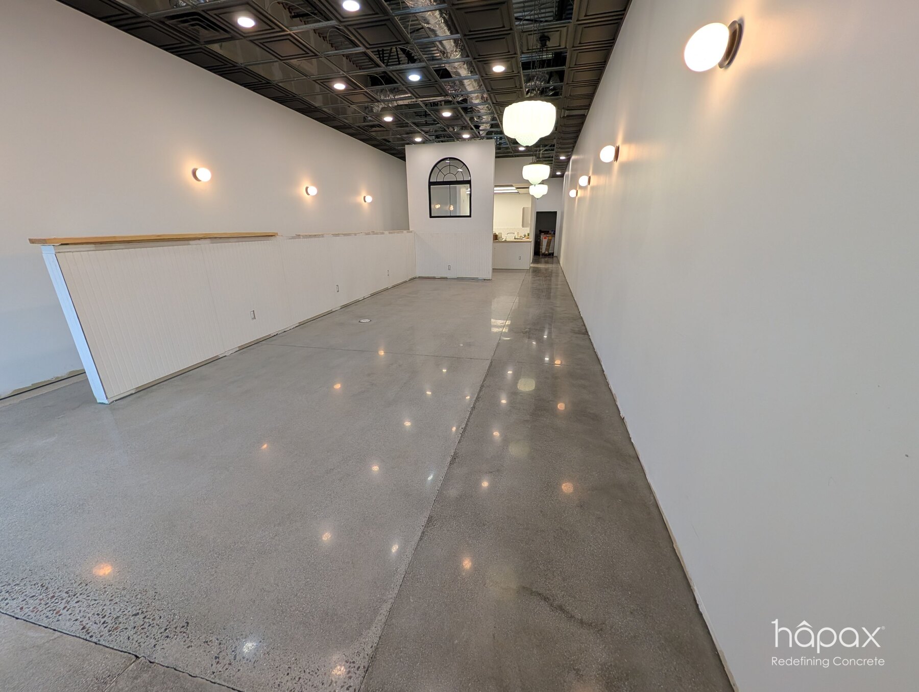 Finished polished concrete floor extending through the bright Lolly’s Great Bridge retail interior in Chesapeake.