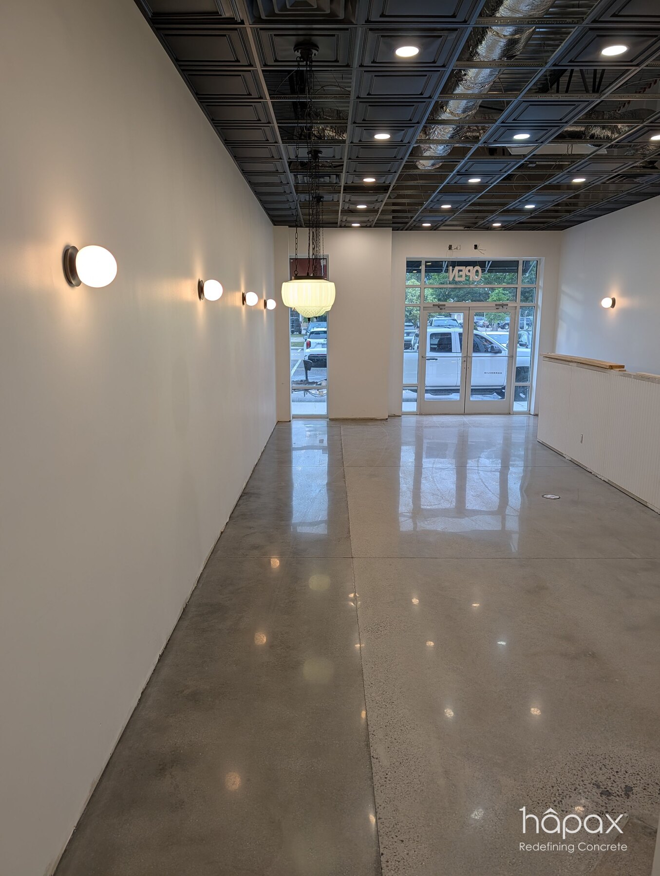 Reverse view of the finished polished concrete floor facing the storefront at Lolly’s Great Bridge.