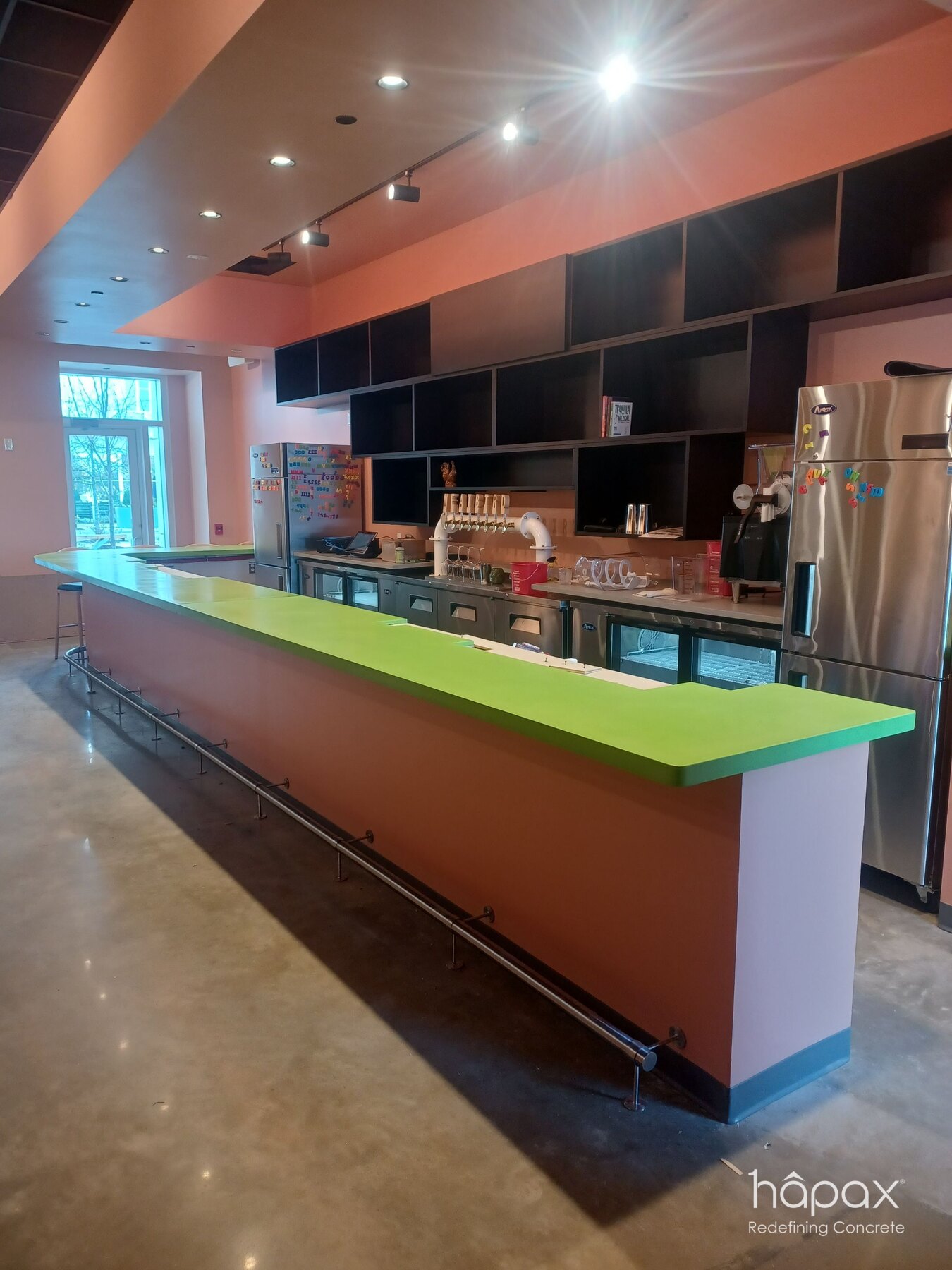 Reverse view of the custom green concrete hospitality counter and coordinated service equipment at Neat Bird.